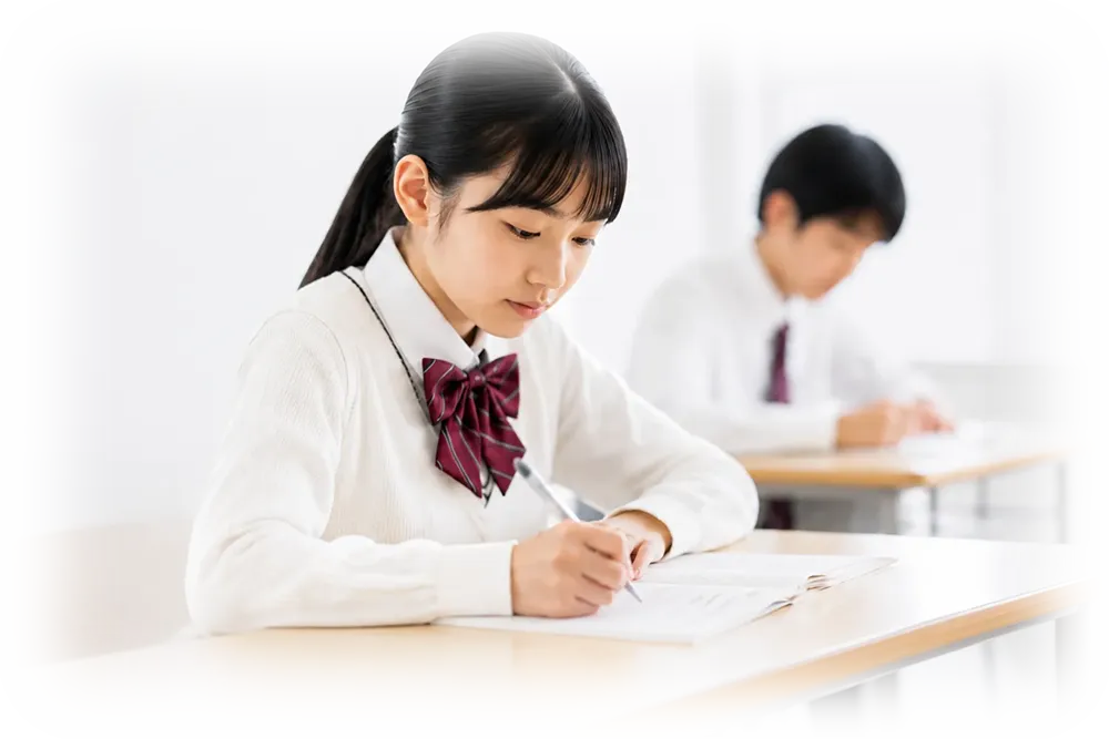 塾の教室で高校生が大学受験勉強をしているシーン
